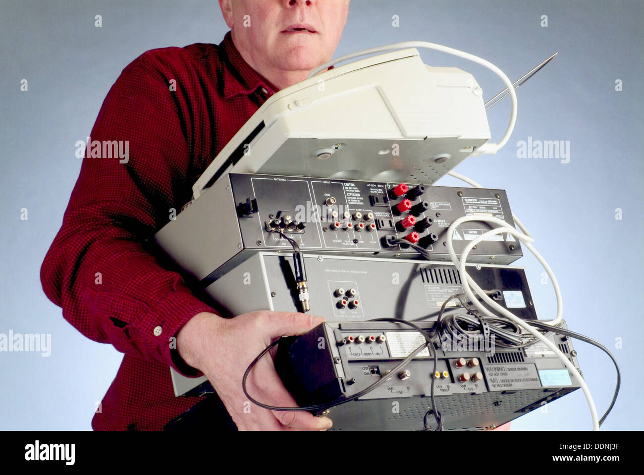 person-carrying-stereo-equipment-and-fax-machine-DDNJ3F.jpg