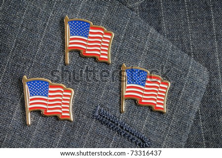 stock-photo-three-american-flag-pins-on-a-pinstripe-suit-lapel-73316437.jpg