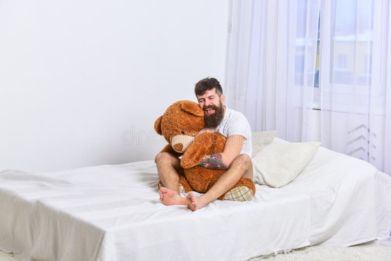 never-grow-up-concept-guy-happy-face-hugs-giant-teddy-bear-macho-beard-mustache-cuddling-plush-toy-man-sits-bed-big-116722832.jpg